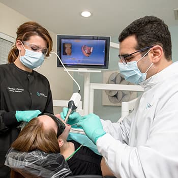 Dr. Khayat, your prosthodontist in Hingham, MA, using modern technology to conduct a exam